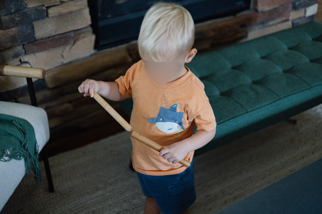 Toddler tapping rhythm sticks