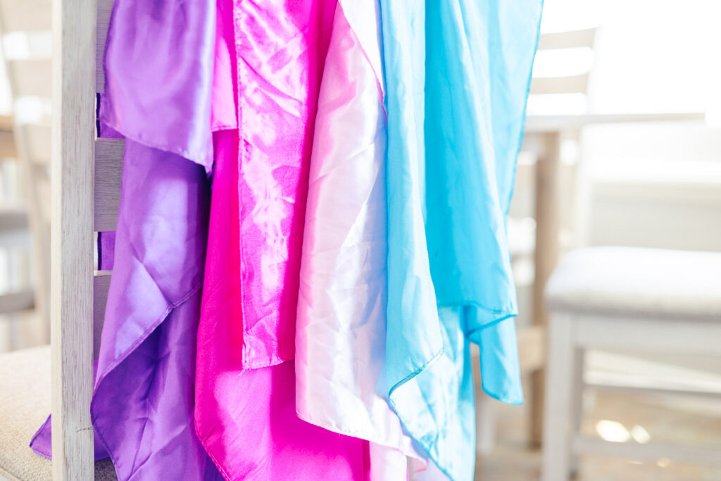 Four scarves of different colors on chair