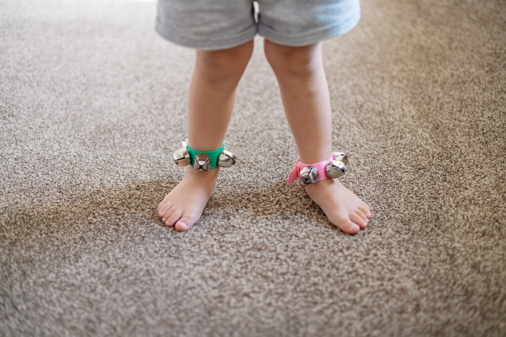 Child with bells around their ankles